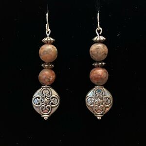 Handcrafted silver tone earrings with brown marbalized and silver beading.